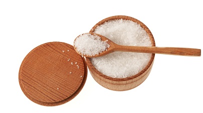 Glutamic acid monosodium salt in wooden bowl with spoon on white background. Msg. Food additive E621. Flavor seasoning for enhancing food impressions